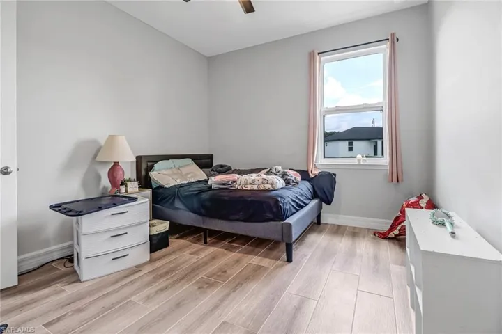 Bedroom with ceiling fan and light wood-type flooring