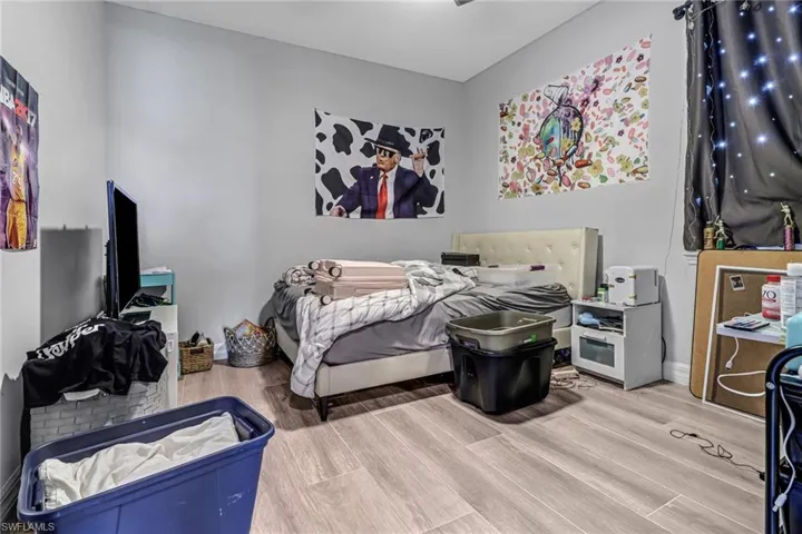 Bedroom with hardwood / wood-style flooring