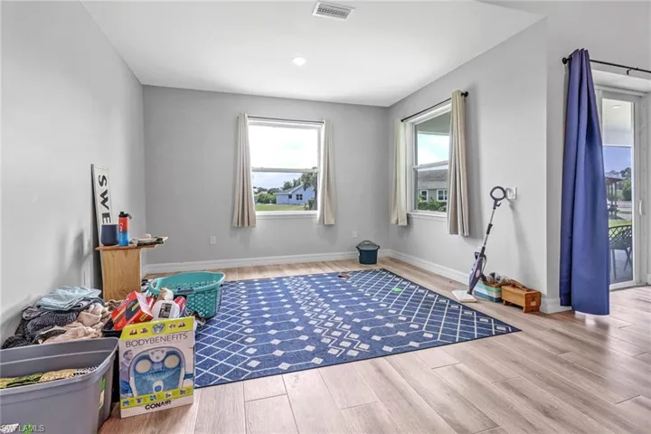 Game room with hardwood / wood-style flooring