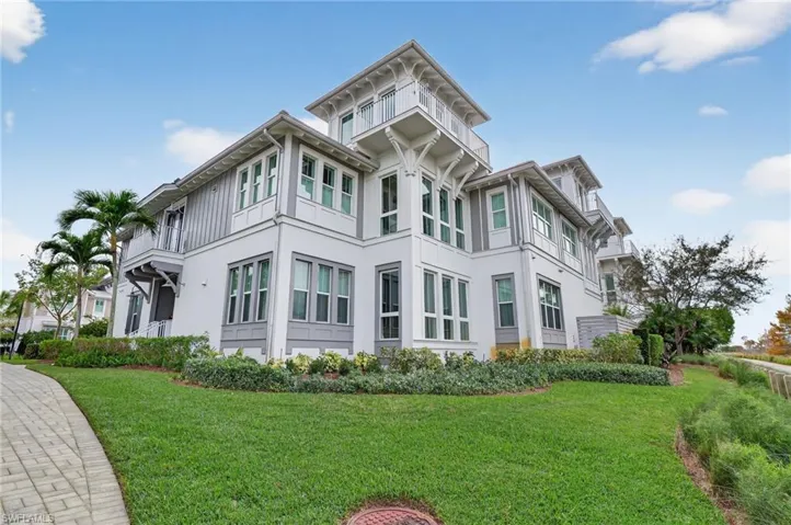 View of property exterior featuring a yard and stucco siding