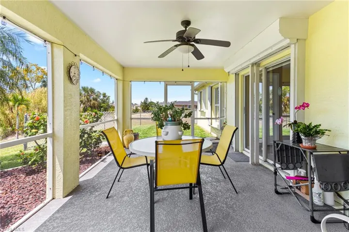 Sunroom featuring ceiling fan and outdoor dining space