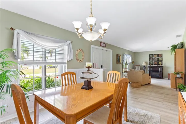 Dining area featuring a chandelier and light wood-style flooring