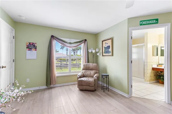 Sitting room featuring light wood-type flooring and baseboards