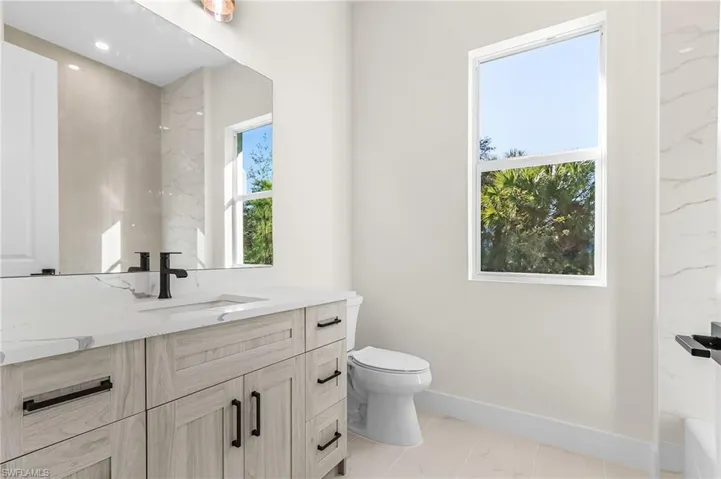 Full bath featuring vanity and toilet