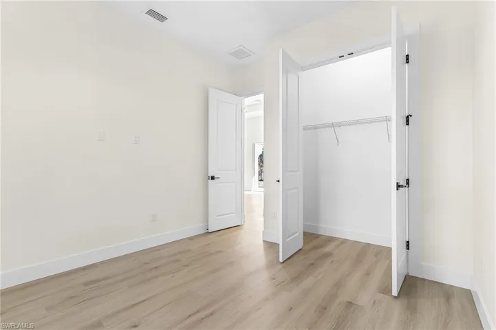 Unfurnished bedroom with a closet and light wood-style floors