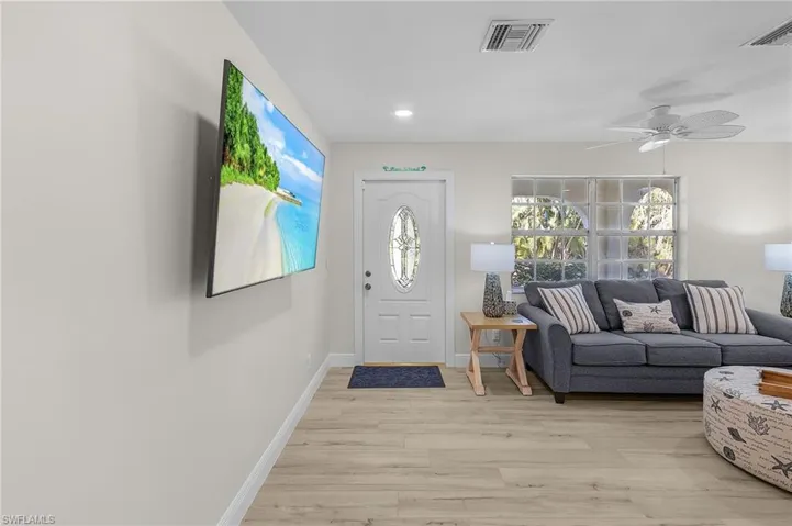 Entryway with light hardwood / wood-style flooring and ceiling fan