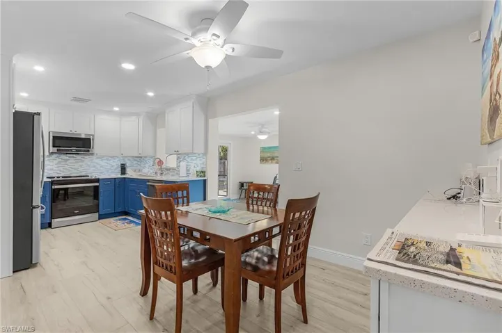 Dining area with ceiling fan and light hardwood / wood-style flooring