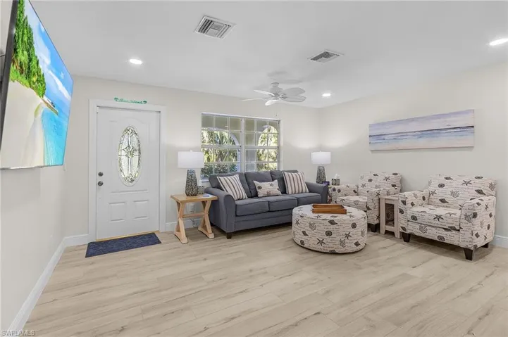 Living room featuring ceiling fan and light hardwood / wood-style floors