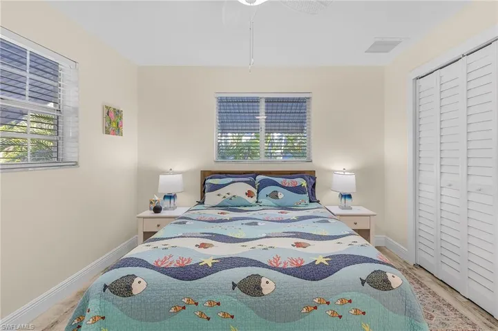 Bedroom featuring ceiling fan, light hardwood / wood-style flooring, and a closet