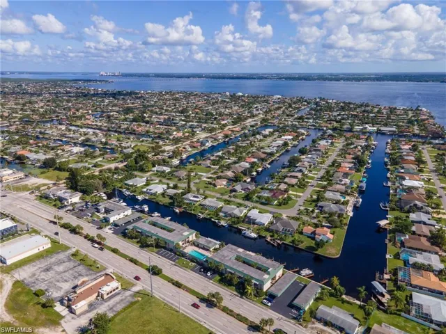 Aerial view featuring a water view and a residential view