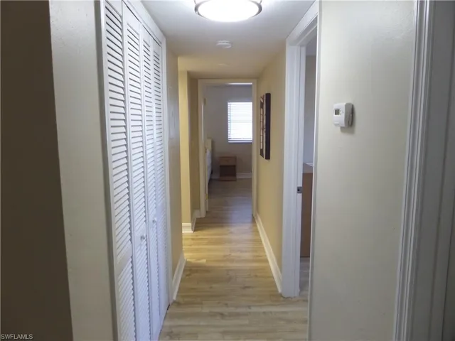 Hall with light hardwood / wood-style flooring