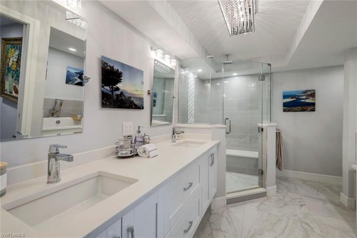 Exquisite en suite primary bath with dual sinks, walk in shower and stand alone modern soaking tub.