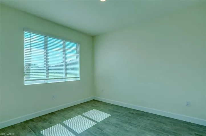 Unfurnished room with hardwood / wood-style floors