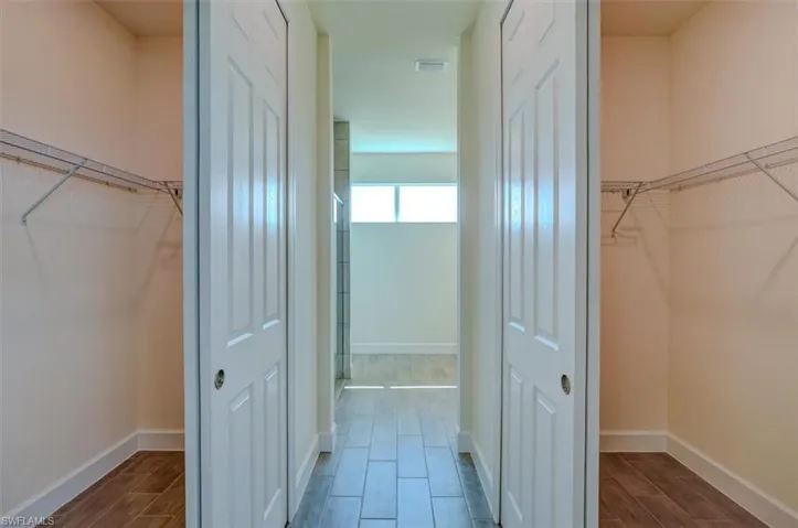 Corridor with hardwood / wood-style floors