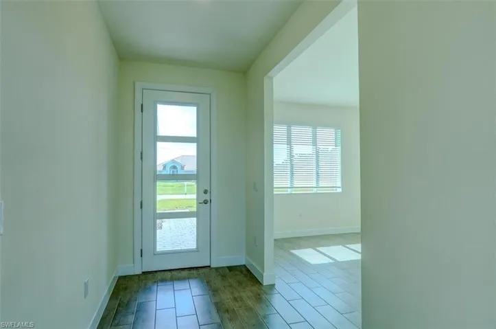Doorway with light hardwood / wood-style flooring