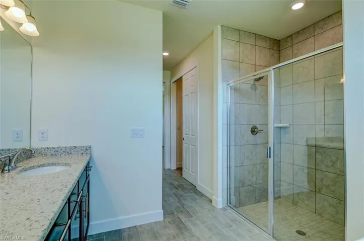 Bathroom with walk in shower and vanity