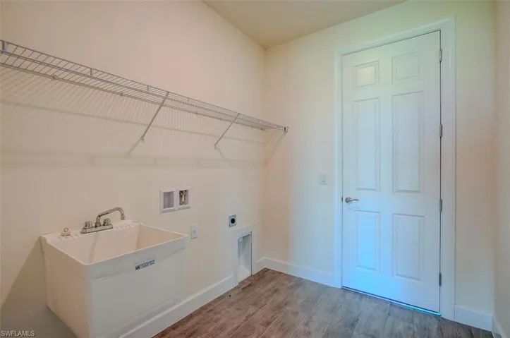 Laundry room with washer hookup, hookup for an electric dryer, and wood-type flooring