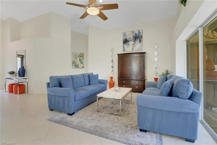 Tiled living room featuring ceiling fan