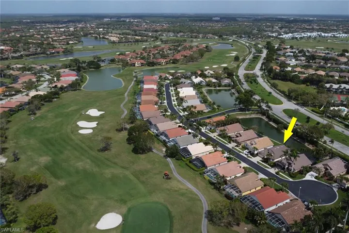 Birds eye view of property featuring golf course view, a water view, and a residential view