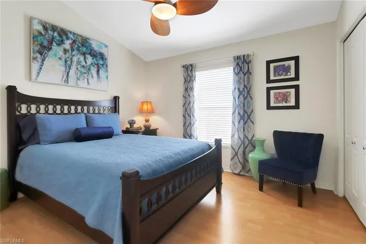 Bedroom with a closet, ceiling fan, and wood finished floors