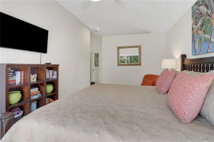 Bedroom featuring vaulted ceiling and ceiling fan