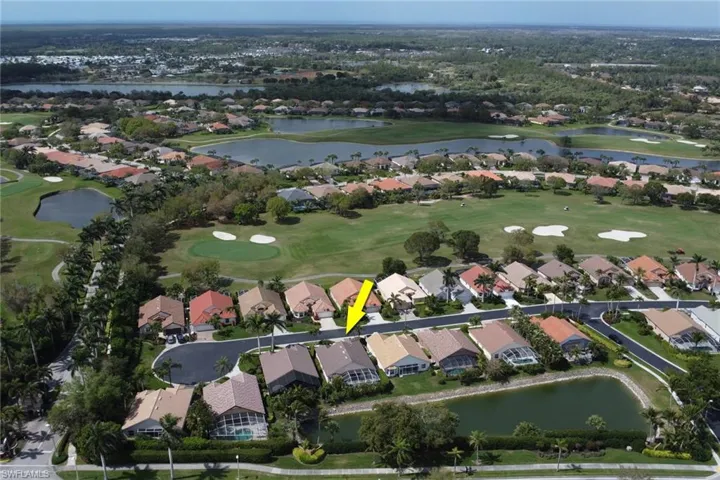 Birds eye view of property featuring view of golf course, a water view, and a residential view