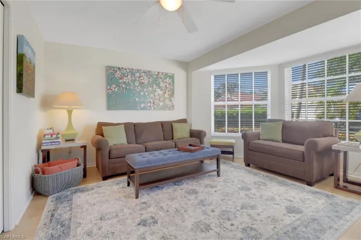 Living room with light hardwood / wood-style floors and ceiling fan