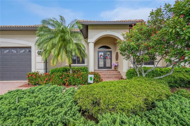 Property entrance featuring a garage and french doors