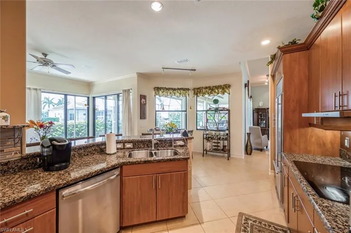 Kitchen with plenty of natural light, sink, dishwasher, and ceiling fan