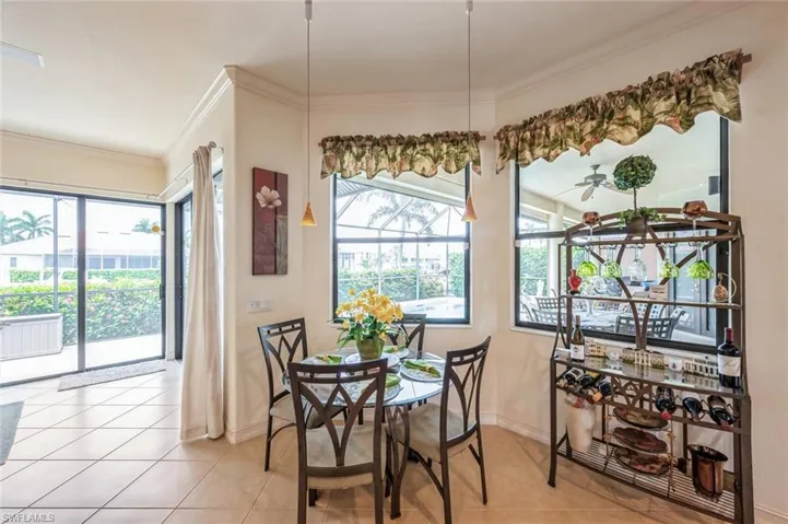 Dining room featuring ceiling fan, ornamental molding, and light tile flooring