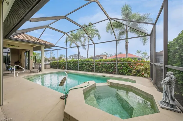 View of swimming pool featuring a lanai, an in ground hot tub, and a patio