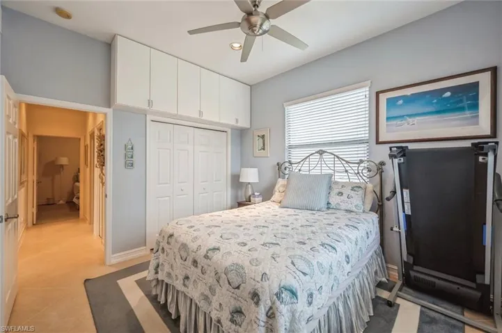 Tiled bedroom featuring a closet and ceiling fan
