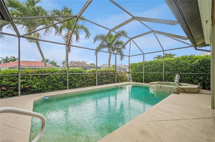 View of swimming pool with a lanai, an in ground hot tub, and a patio