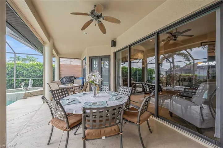 Sunroom / solarium with ceiling fan and french doors