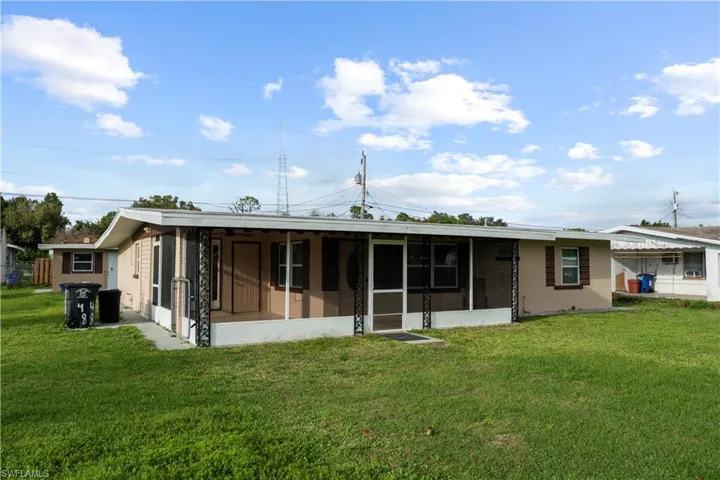 Front of property with a sunroom and a yard