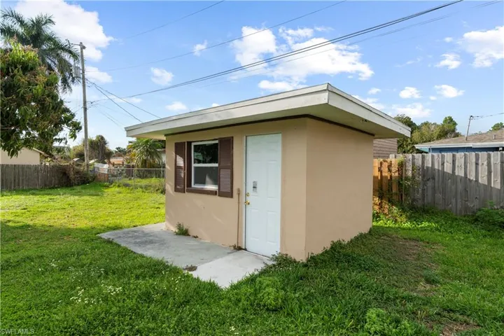 View of shed with a fenced backyard