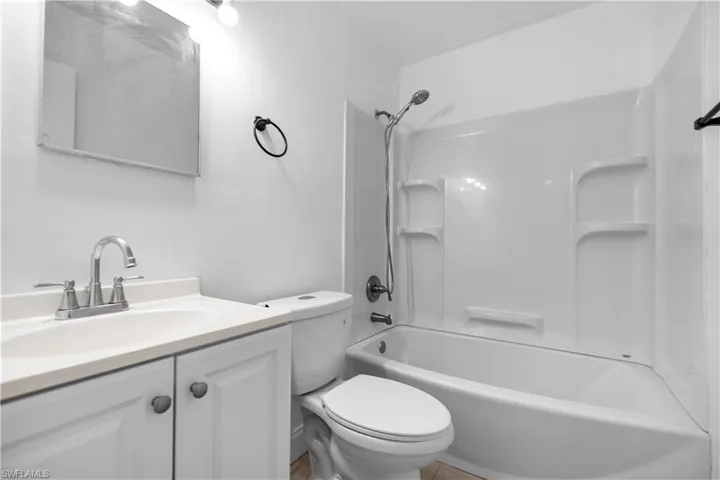Bathroom with vanity and bathing tub / shower combination