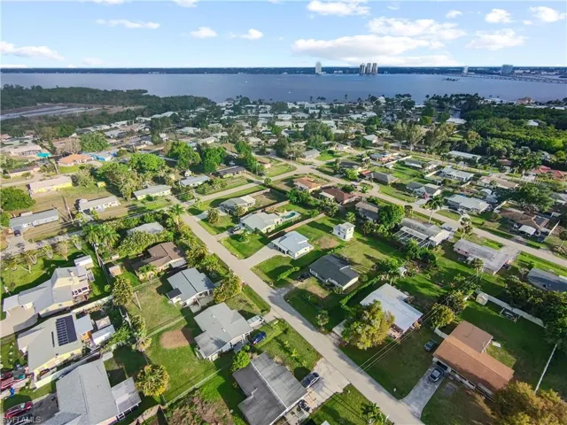 Aerial perspective of suburban area featuring a large body of water