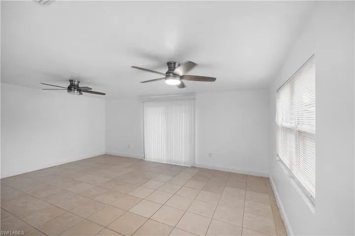 Spare room with a ceiling fan and light tile patterned floors