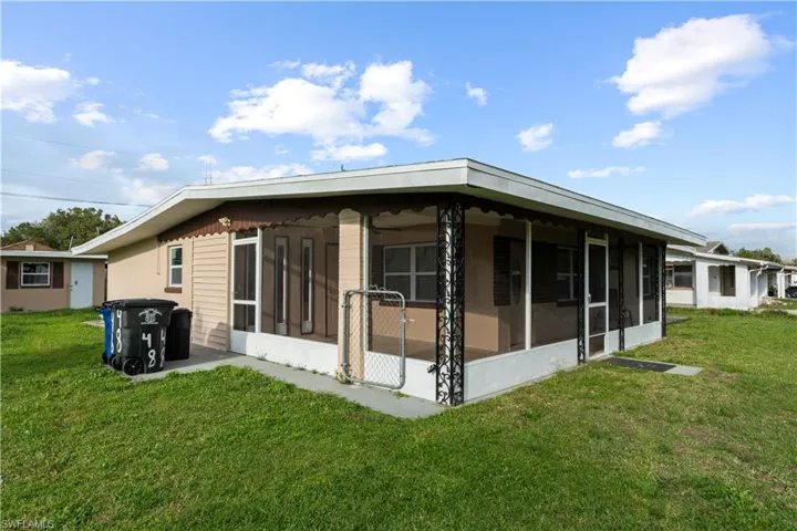 View of property exterior featuring a yard and a sunroom