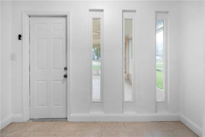 Entrance foyer featuring baseboards and light tile patterned flooring
