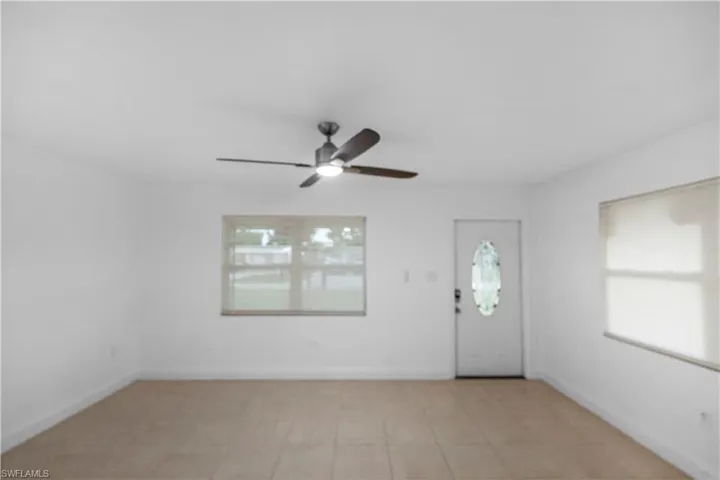 Foyer with ceiling fan and light tile patterned floors