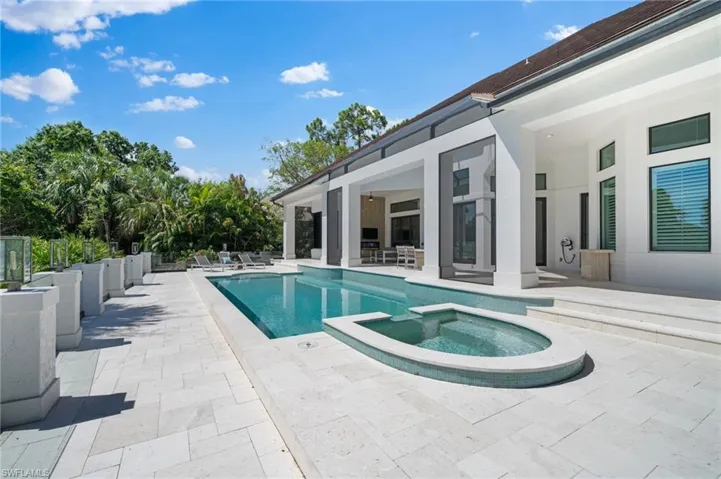 View of pool with ceiling fan, an in ground hot tub, and a patio
