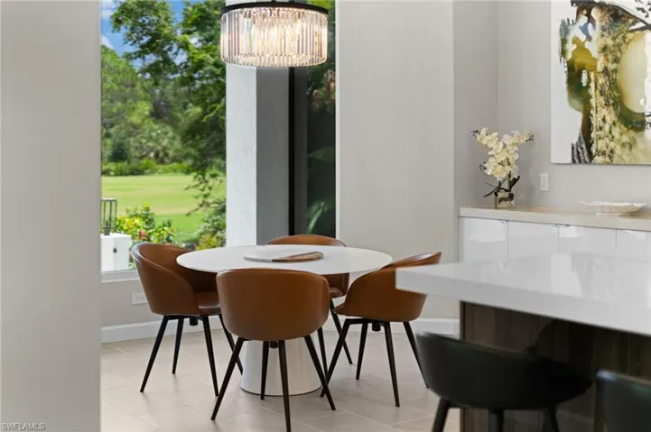 Tiled dining space featuring a chandelier