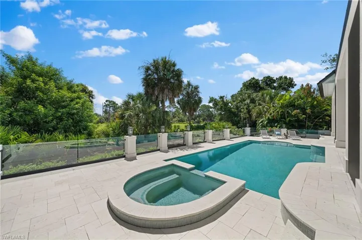 View of pool featuring a patio and an in ground hot tub