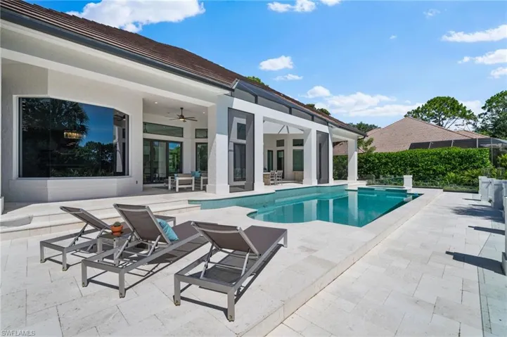 View of swimming pool featuring a patio and ceiling fan