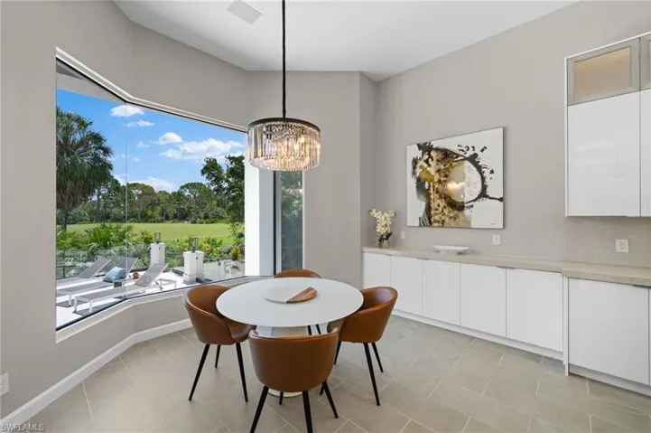 Tiled dining area with a notable chandelier