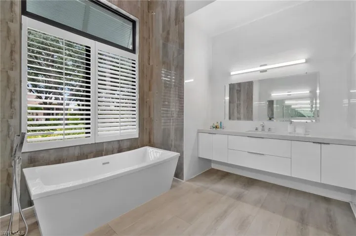 Bathroom featuring a bath and vanity