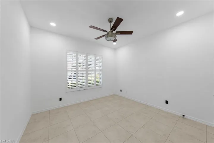 Recessed lighting, ceiling fan, plantation shutters, and tiled flooring