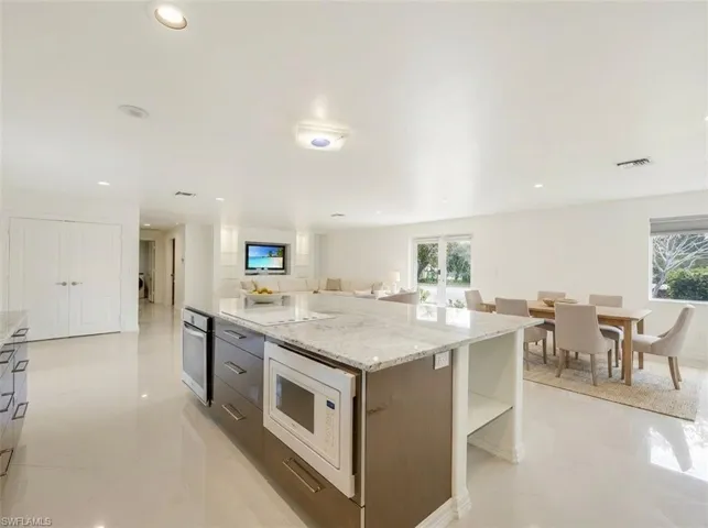 Kitchen island with integrated microwave and granite-style countertop